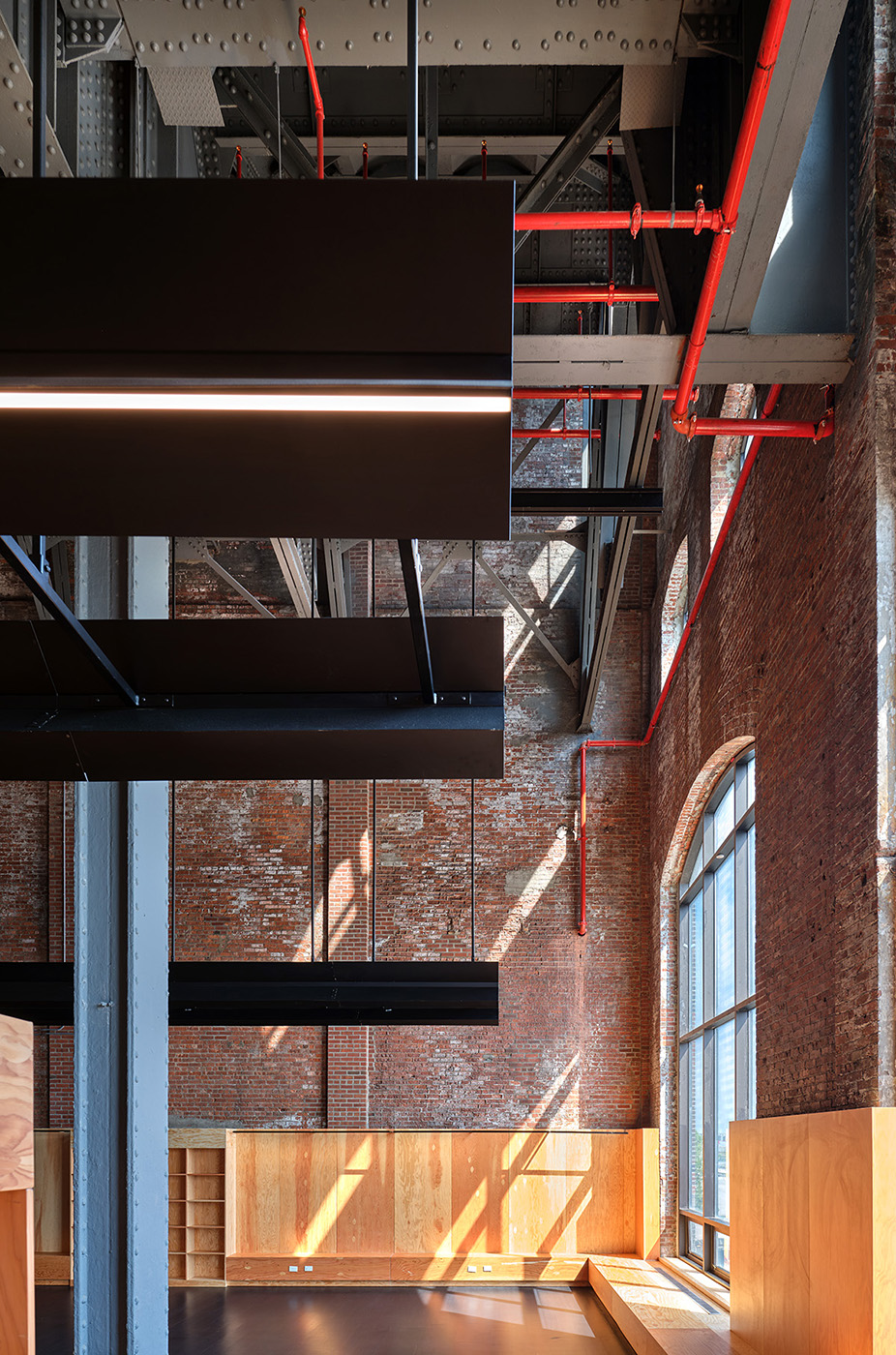 Light coming from large windows in converted warehouse building
