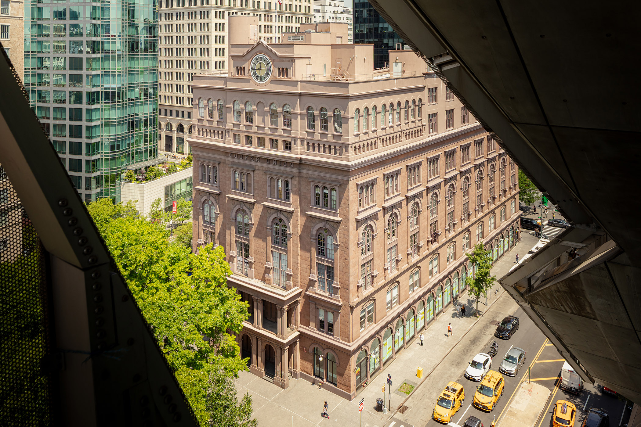 Historic brownstone academic building topped with a clock
