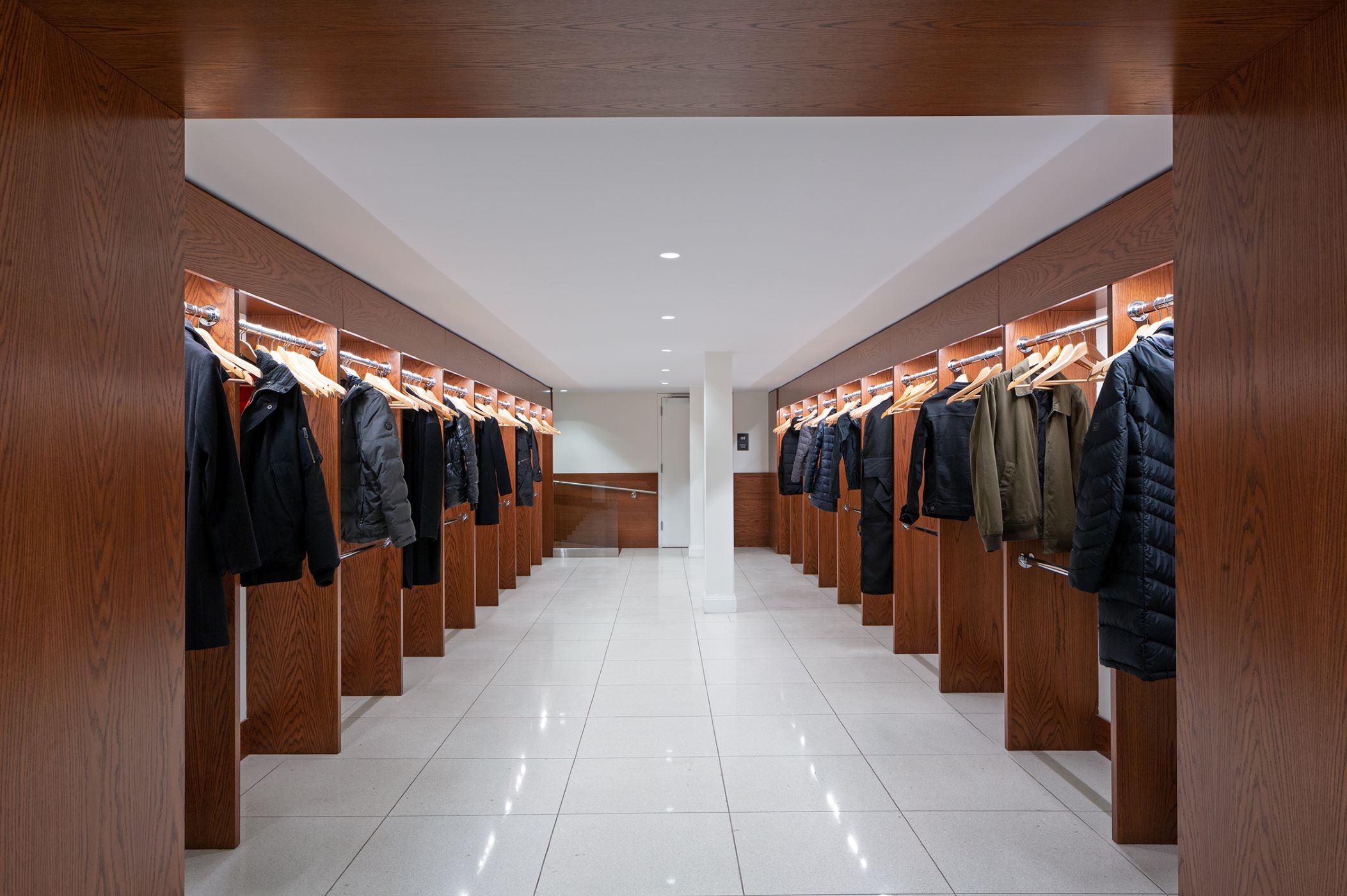 large coat closet with dark timber finishes