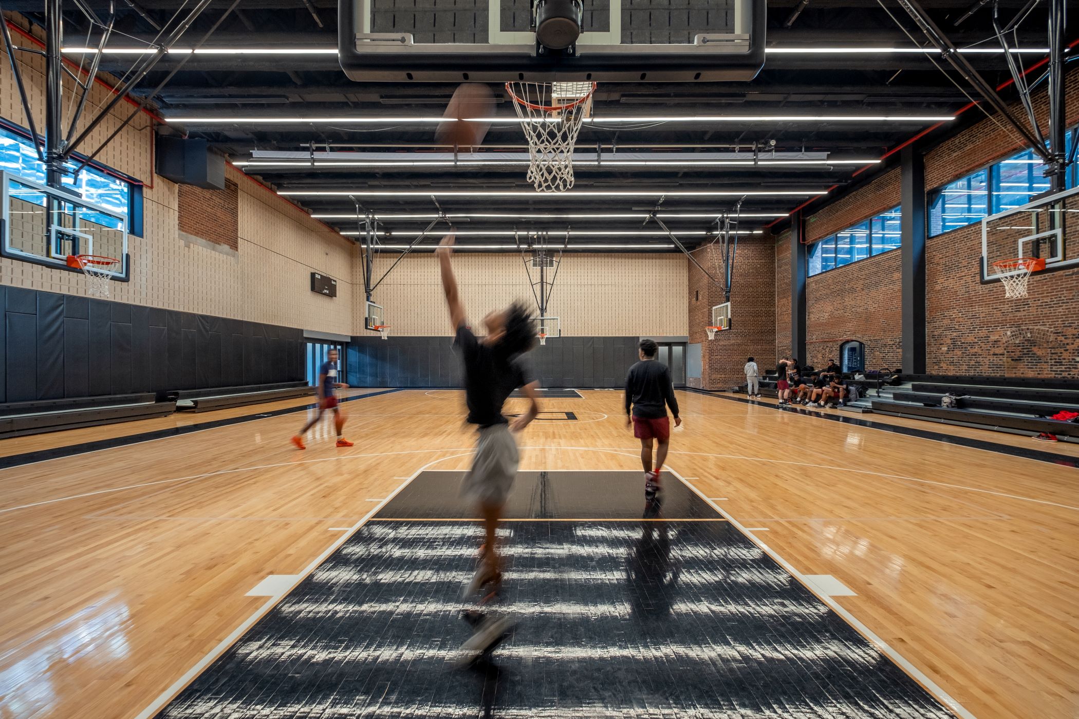 Kids playing basketball in a gymnasium