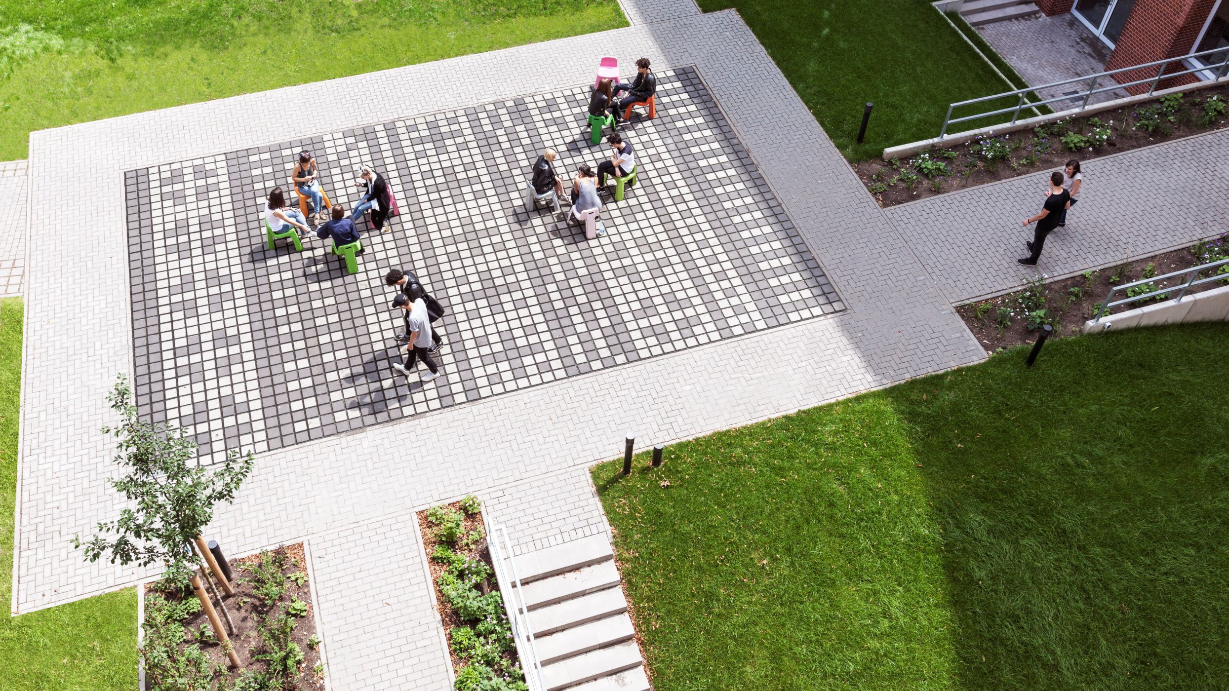 Aerial photo with students sitting in a paved plaza