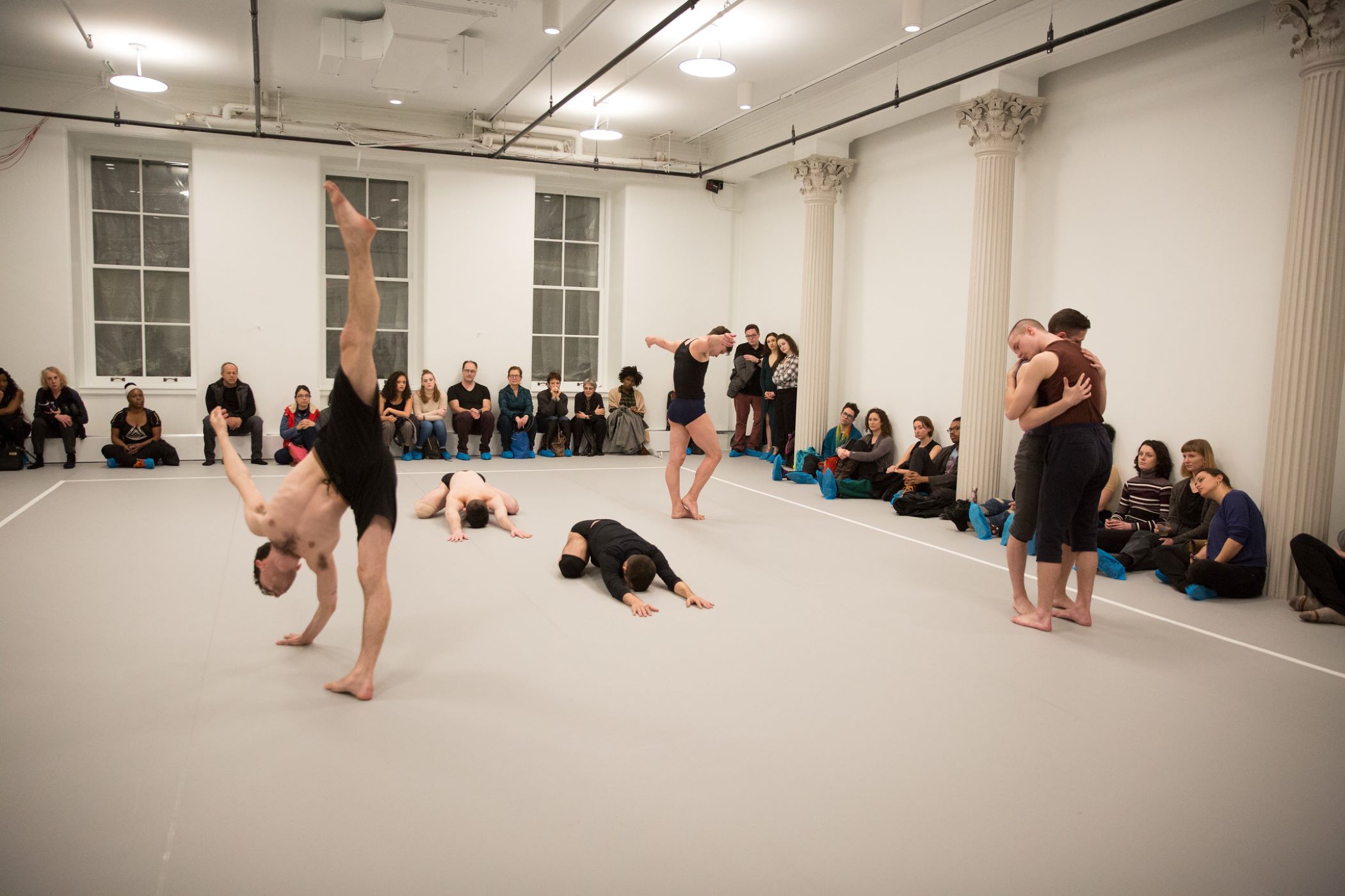 large, open dance studio with many dancers in different positions