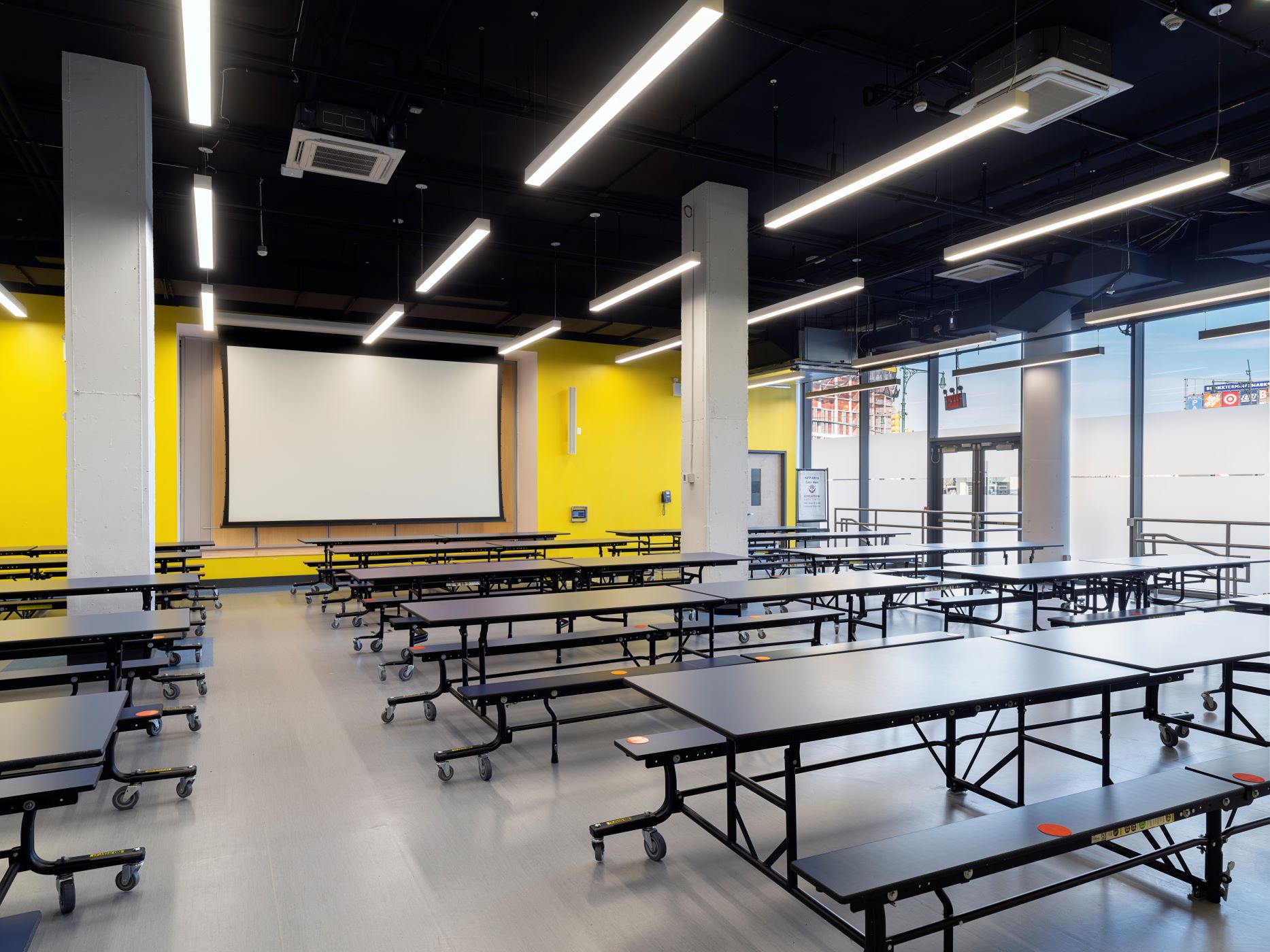 cafeteria in a school with a bright yellow wall