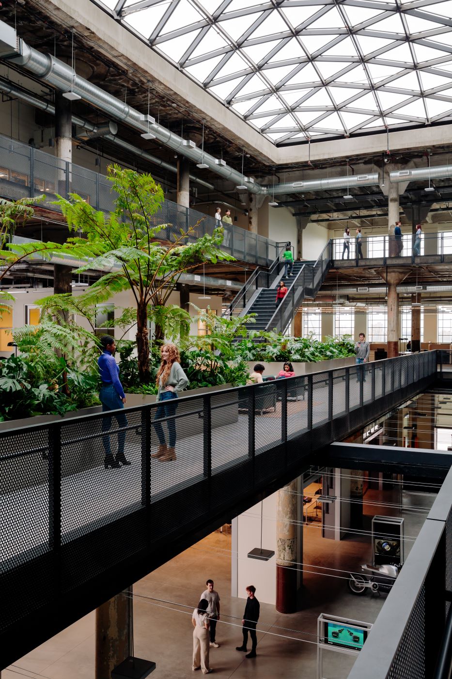 Internal atrium with plants and people chatting