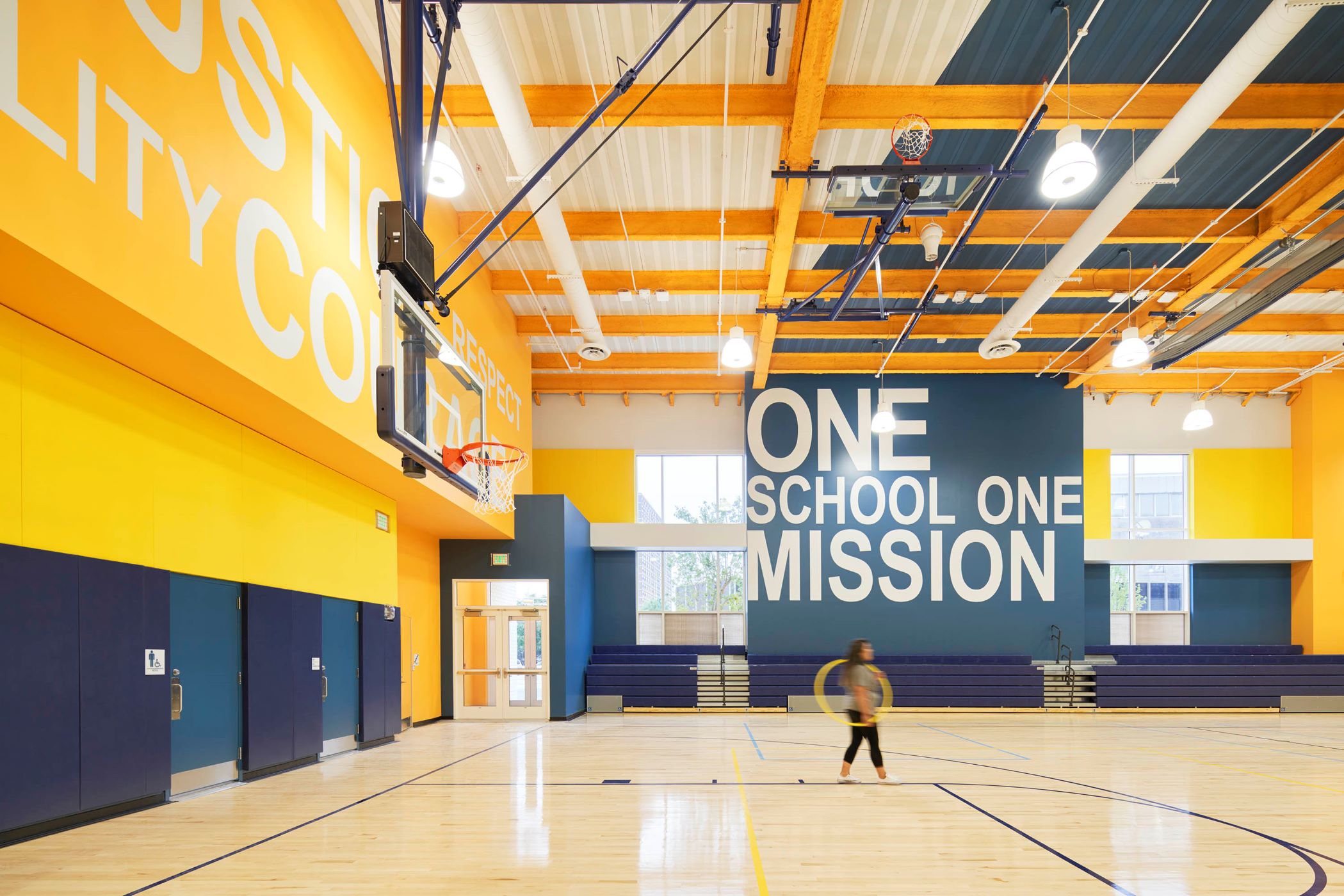Gymnasium with a kid in the middle, featuring yellow and blue colors
