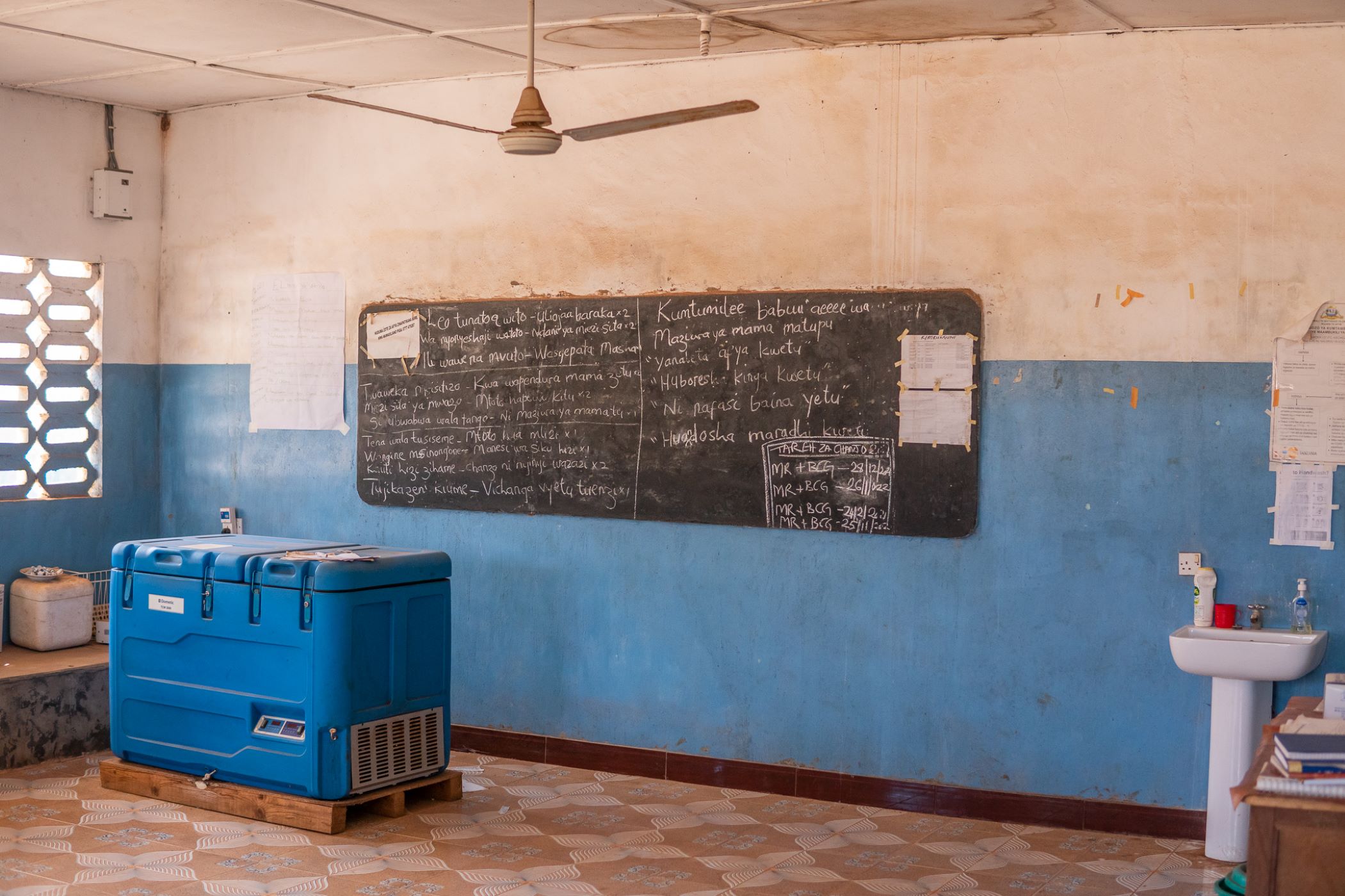 building interior painted half white and half blue in tanzania, chalk board on the wall
