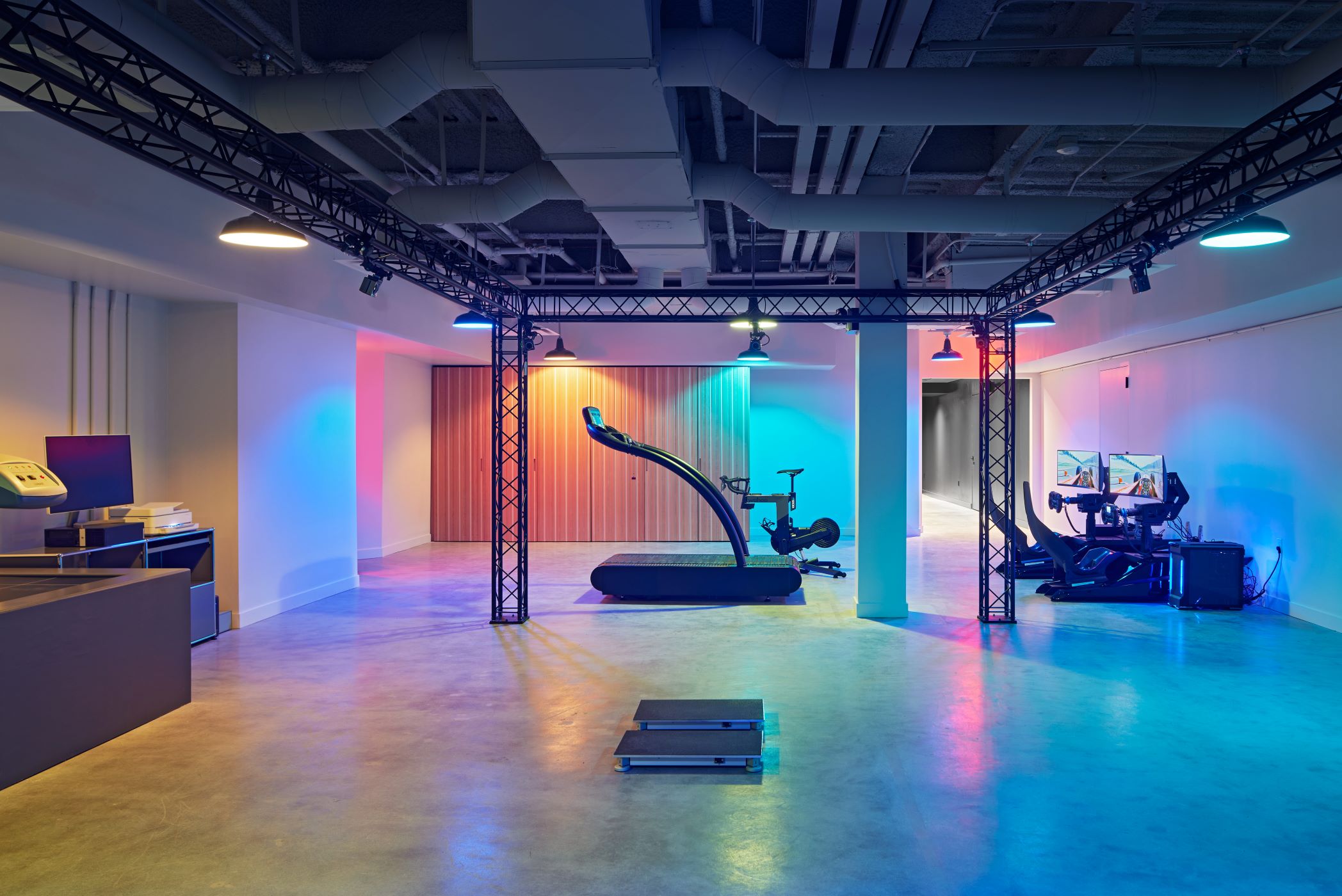 multi-colored lighting gym space with treadmill in background