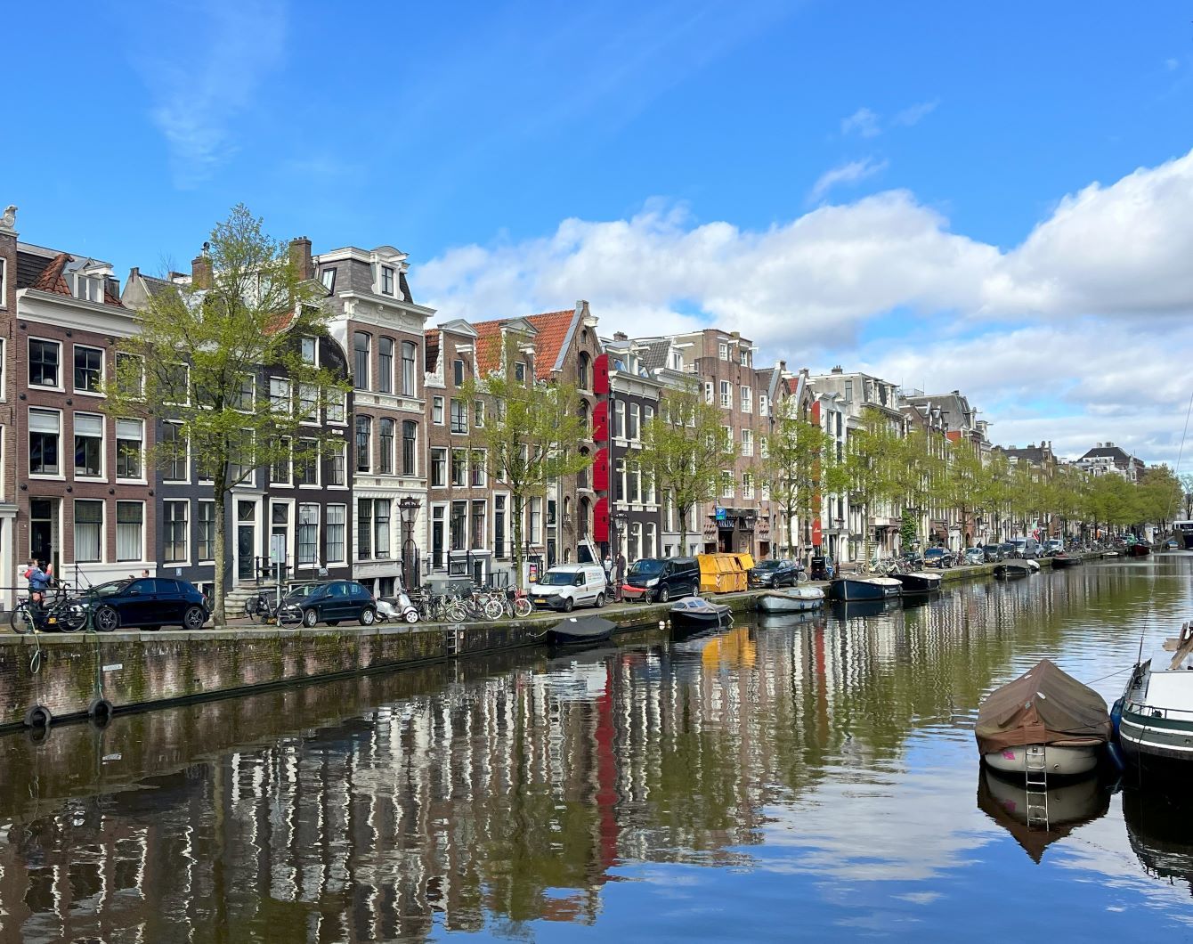 canal in amsterdam with colorful buildings