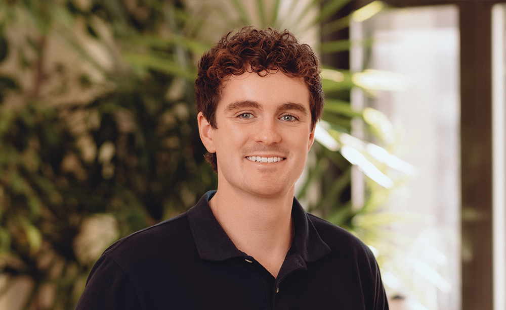 Man in black polo shirt in an office