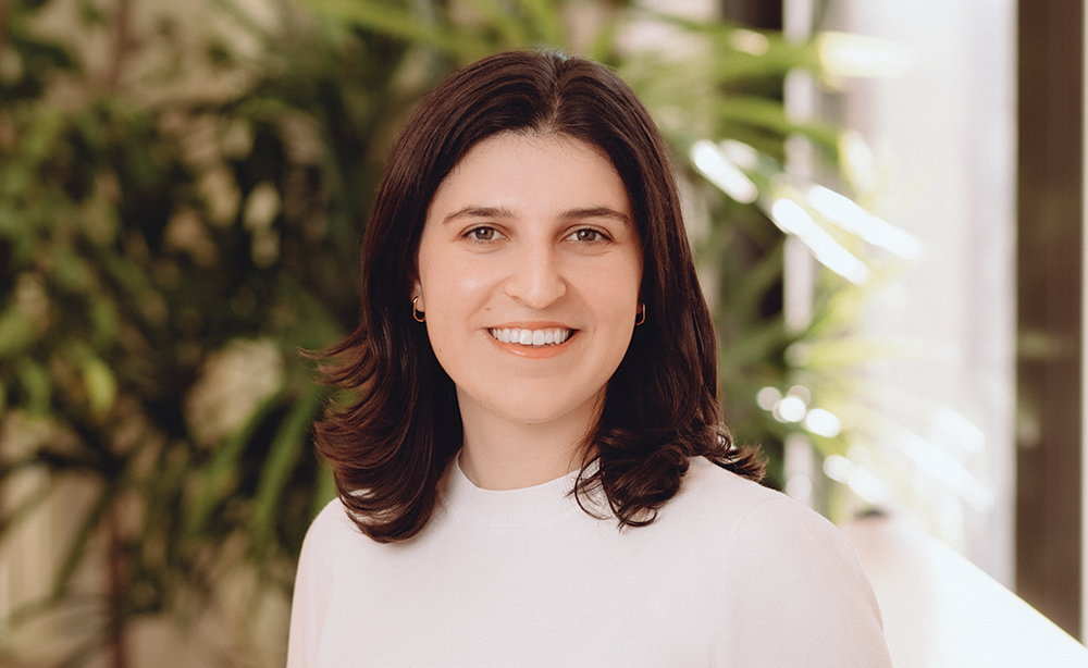 Woman in white shirt standing in office