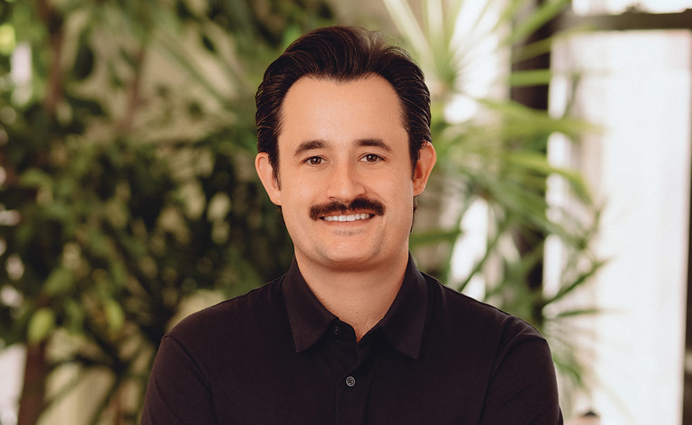 Man in black shirt standing in office