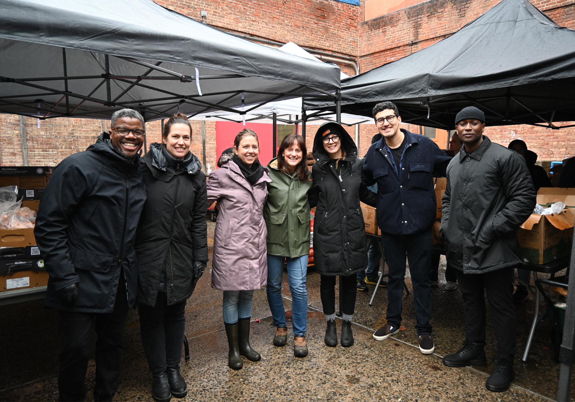 group of people posing for a photograph during a volunteer event