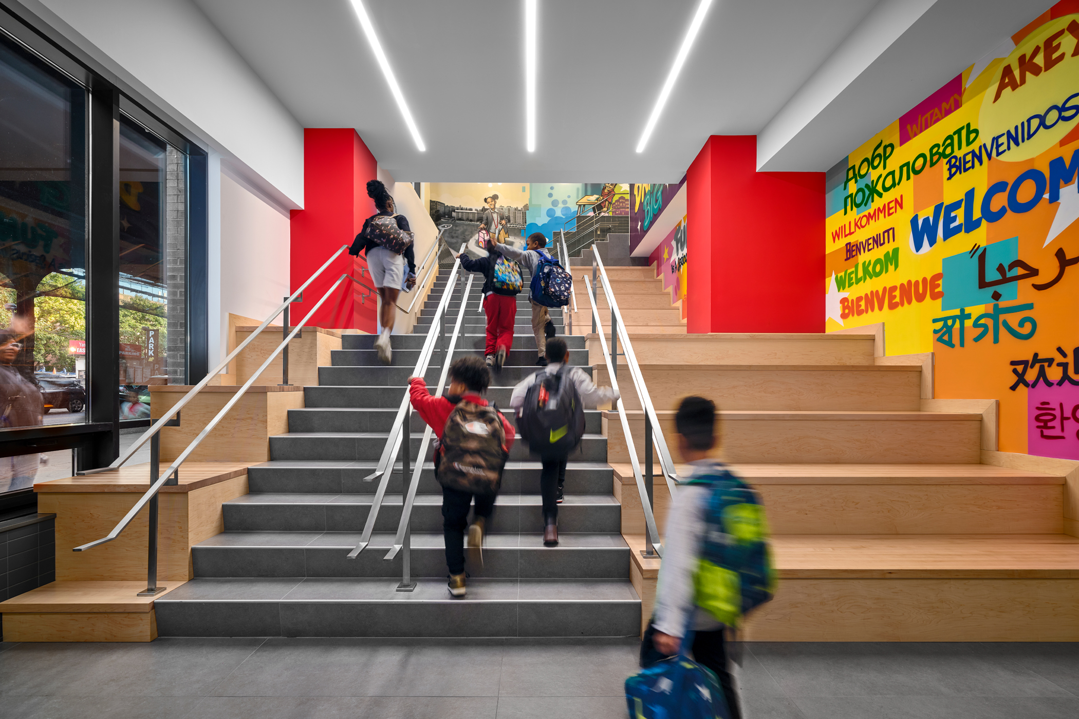 Indoor photo showing schoolkids going up stairs