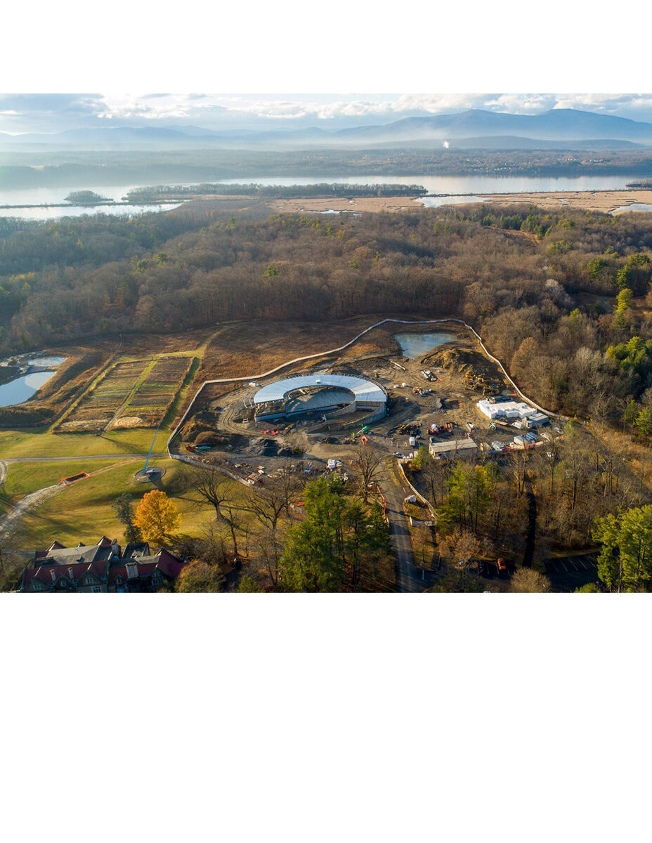 Aerial of circular building under construction along the Hudson River