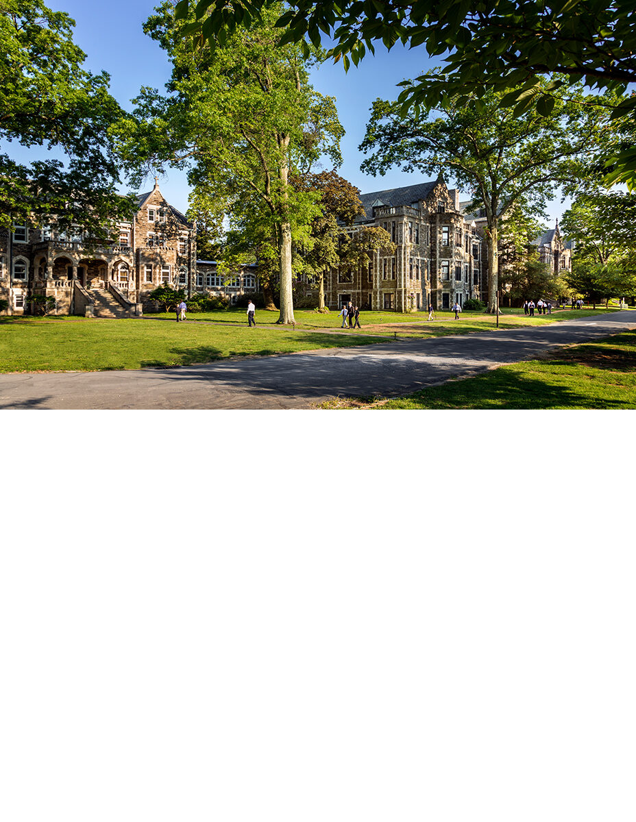 historic campus behind old-growth trees
