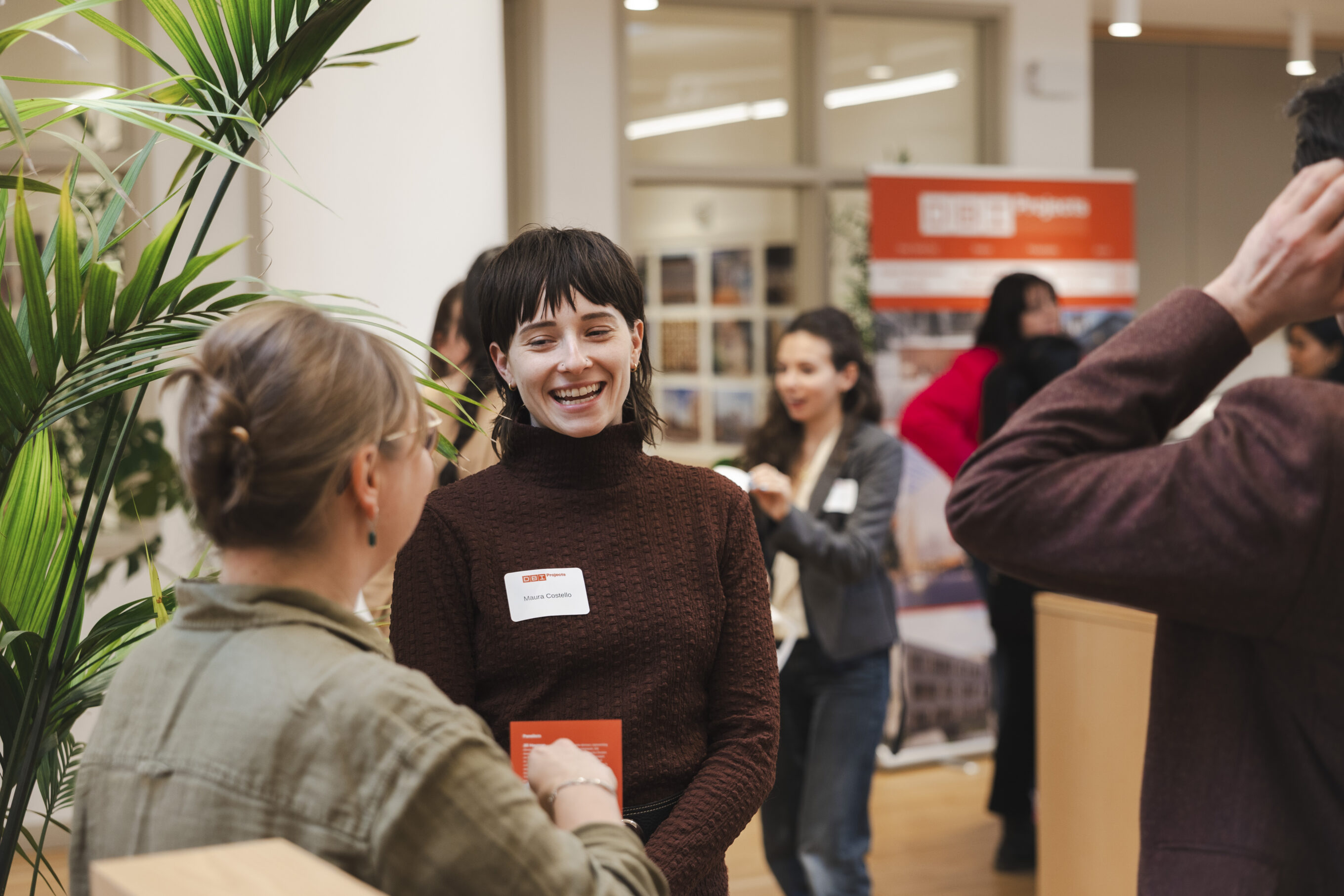 photo of people speaking during an office event