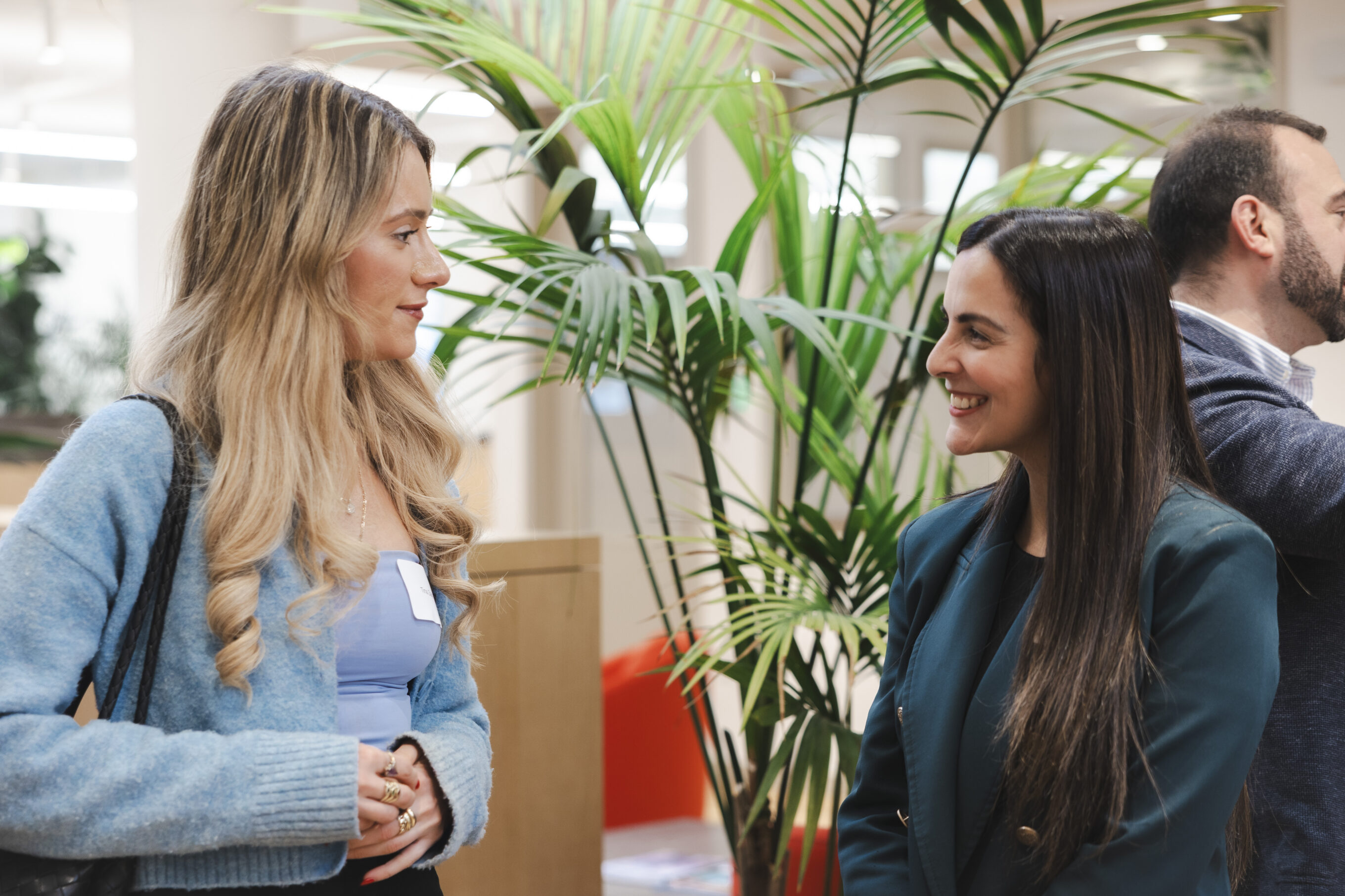 photo of two women talking to each other during an office event